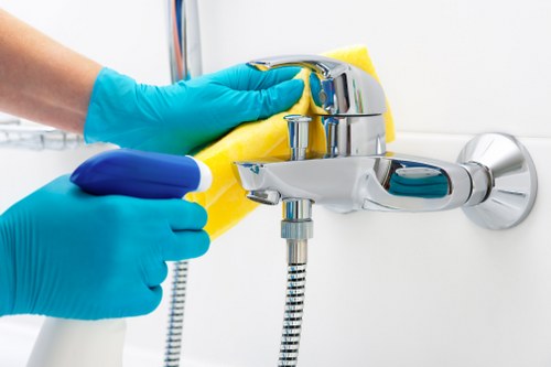 Worker handling carpet cleaning tools with protective gloves and care