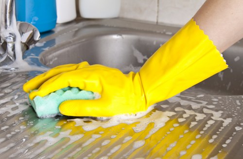 Cleaner restoring a fabric sofa with upholstery cleaning in Catford